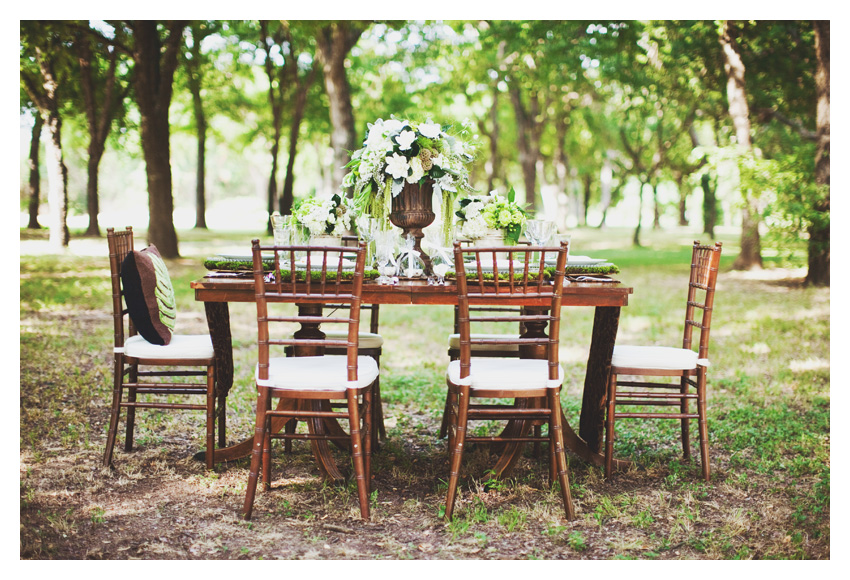 Vintage garden themed brown and green bridal shower event design featuring dark wood mahogany chiviari chairs, wooden table, moss, antique keys, roses, and wooden plates