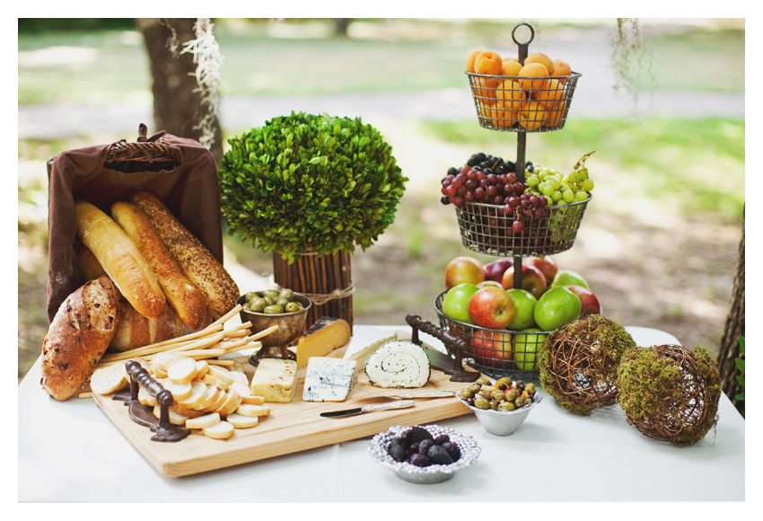 Vintage garden themed brown and green bridal shower event design featuring dark wood mahogany chiviari chairs, wooden table, moss, antique keys, roses, and wooden plates