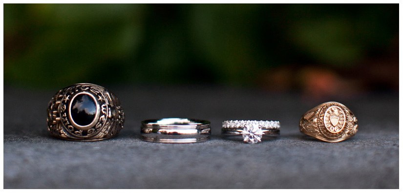 wedding band and engagement ring detail shot photo with Aggie Ring and US Naval Academy ring on garden step