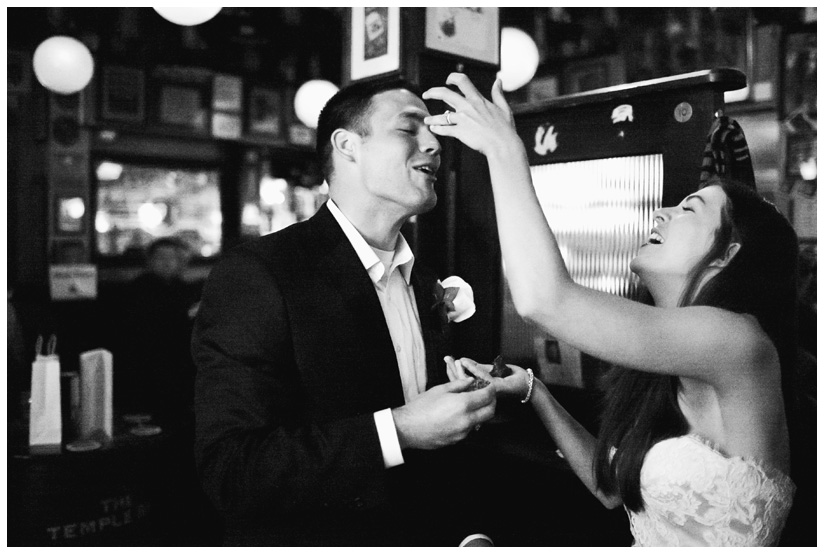 Erin Mazur and Tyler Hufstetler feed each other wedding cake at Temple Bar in Dublin Ireland during their wedding reception