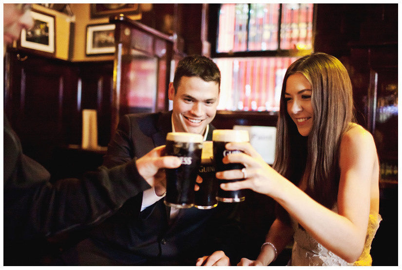 bride and groom toast with pints of Guinness at the famous Temple Bar in downtown Dublin Ireland