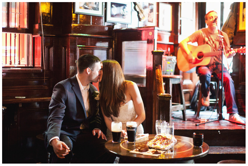 destination bride and groom toast with pints of Guinness at the famous Temple Bar in downtown Dublin Ireland